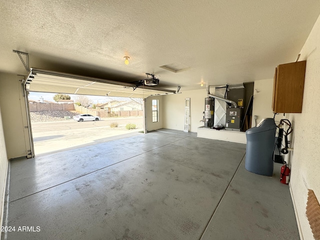 garage with water heater, heating unit, and a garage door opener