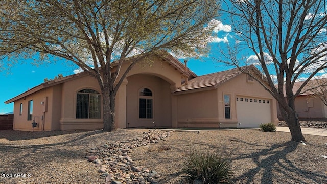 view of front of house with an attached garage and stucco siding