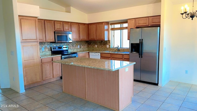 kitchen with light stone countertops, tasteful backsplash, appliances with stainless steel finishes, and a sink