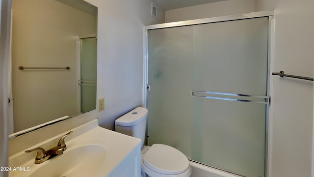 full bathroom with toilet, vanity, an enclosed shower, and visible vents