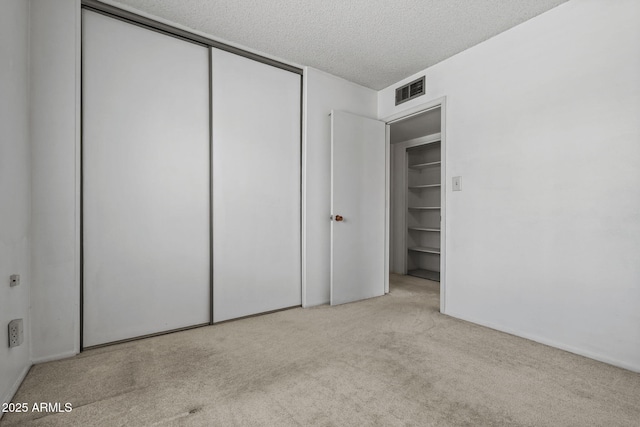2264 S Don Carlos, Mesa, AZ 85202 - unfurnished bedroom with carpet, a textured ceiling, and a closet