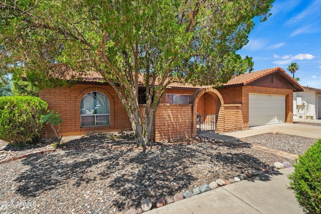 2264 S Don Carlos, Mesa, AZ 85202 - view of front facade with concrete driveway, an attached garage, brick siding, and a tile roof