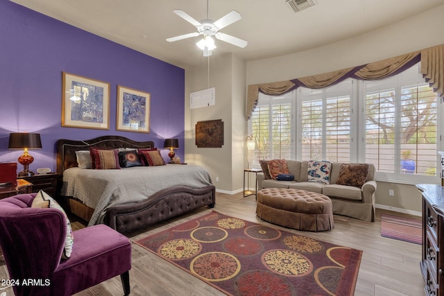 bedroom with light hardwood / wood-style flooring and ceiling fan