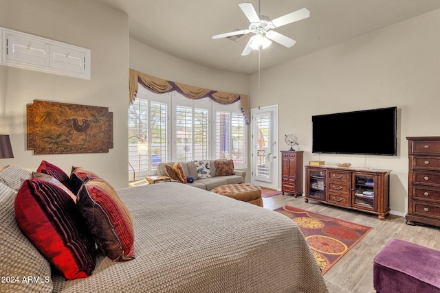 bedroom with light hardwood / wood-style flooring, access to exterior, and ceiling fan