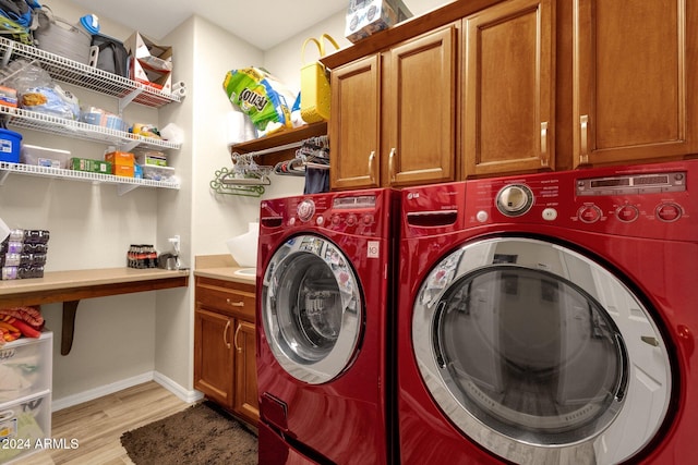 clothes washing area with light hardwood / wood-style floors, cabinets, and separate washer and dryer