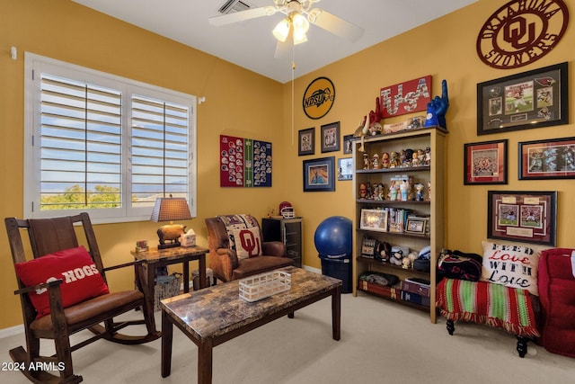 living area featuring ceiling fan and light colored carpet