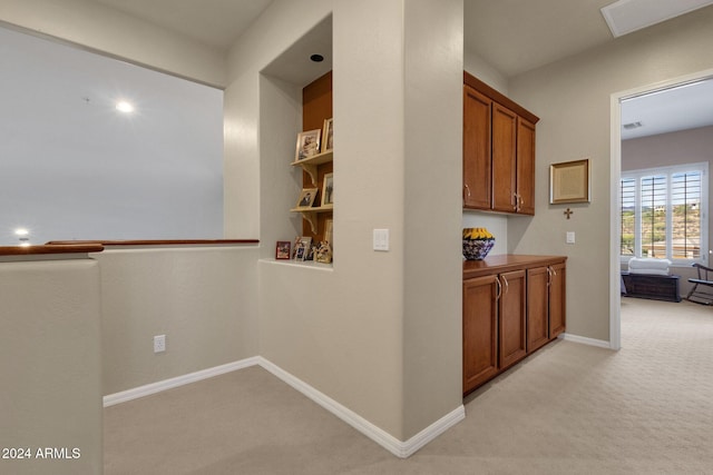 hall featuring light colored carpet