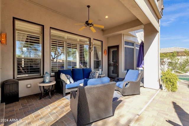 view of patio / terrace with an outdoor living space and ceiling fan