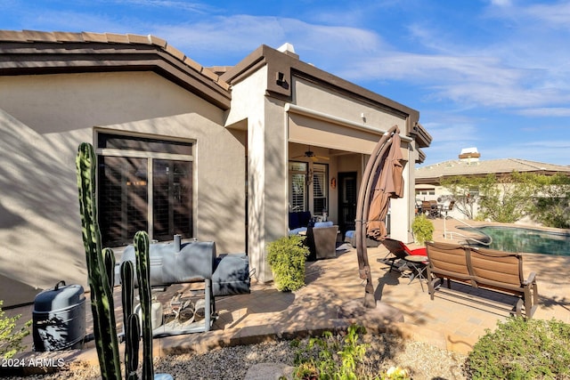 back of property featuring a patio area and an outdoor living space