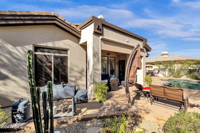 15439 E Acacia Way, Fountain Hills, AZ 85268 - rear view of house with ceiling fan, a patio, stucco siding, and an outdoor pool
