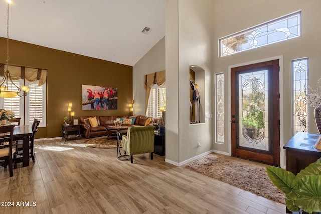 15439 E Acacia Way, Fountain Hills, AZ 85268 - entryway with wood finished floors, a towering ceiling, visible vents, an inviting chandelier, and baseboards