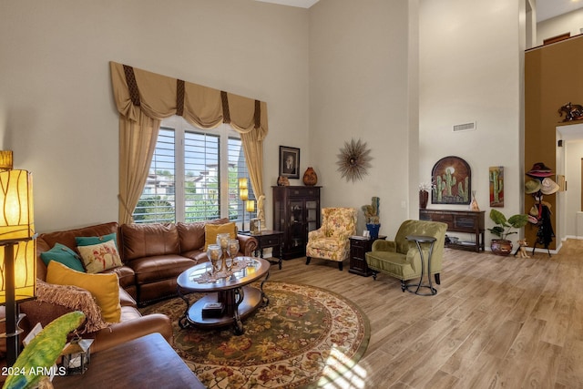 15439 E Acacia Way, Fountain Hills, AZ 85268 - living area featuring light wood finished floors, visible vents, and a high ceiling