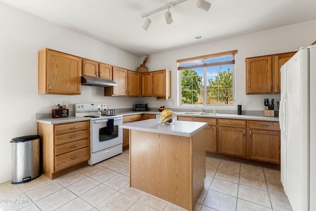 kitchen featuring sink, white appliances, a center island, and light tile patterned floors