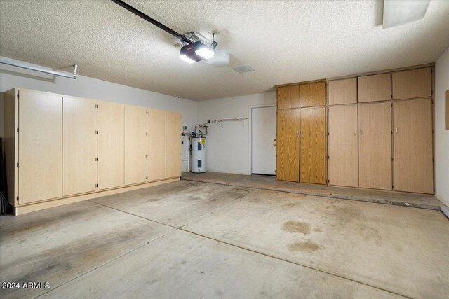 garage with electric water heater and a garage door opener