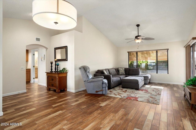 living room with a textured ceiling, high vaulted ceiling, dark hardwood / wood-style flooring, and ceiling fan