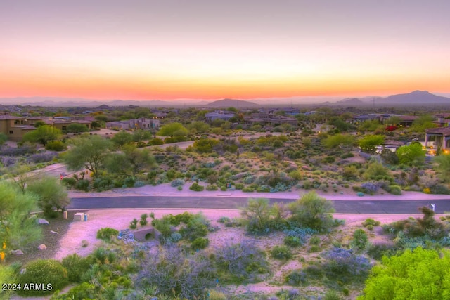 aerial view at dusk featuring a mountain view