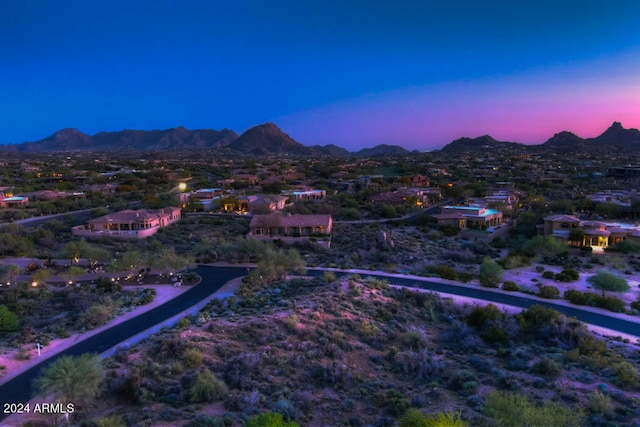 aerial view at dusk featuring a mountain view