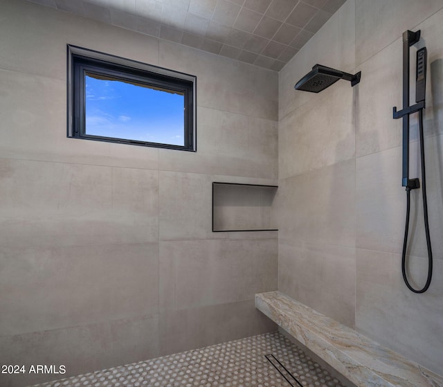 bedroom with ceiling fan, a tiled fireplace, a raised ceiling, and access to outside