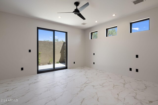 bathroom with toilet, a wealth of natural light, and a tile shower