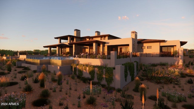 back house at dusk with a patio area