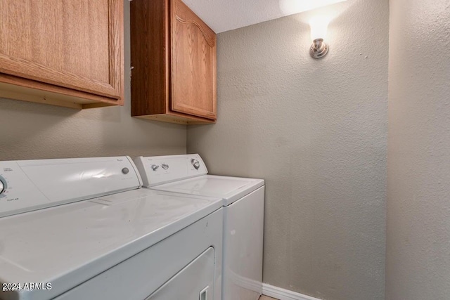 laundry area with cabinets and washing machine and dryer