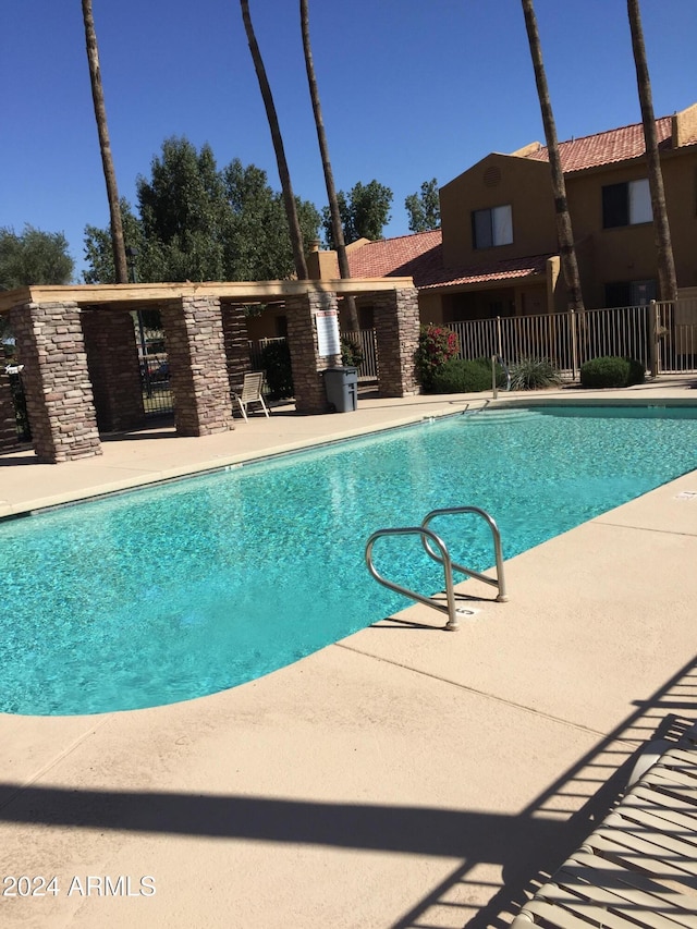 view of swimming pool with a patio area