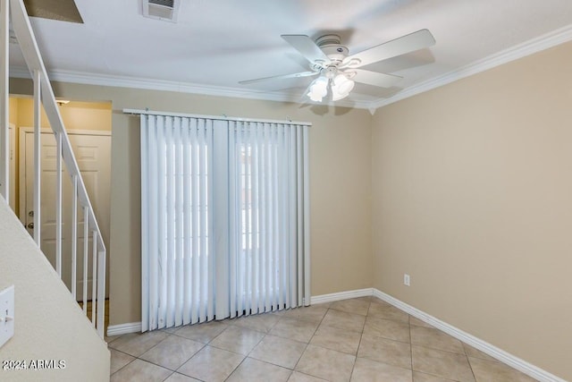 tiled spare room featuring crown molding and ceiling fan