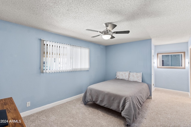 bedroom featuring carpet floors, a textured ceiling, and ceiling fan