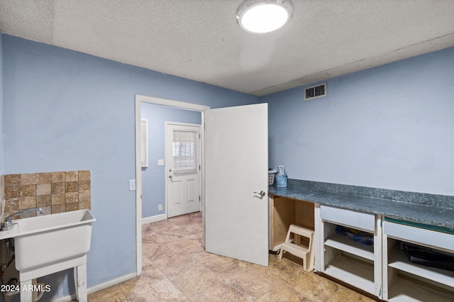 interior space featuring a textured ceiling