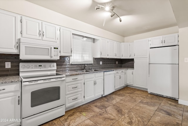 kitchen featuring white cabinets, sink, white appliances, and stone countertops