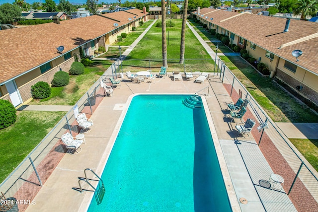 view of pool featuring a yard and a patio area