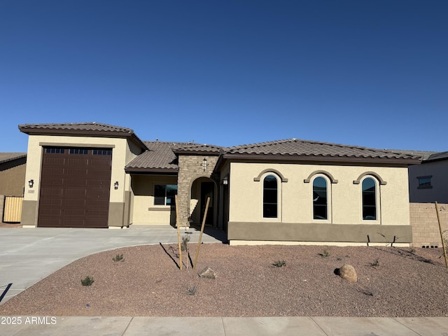 mediterranean / spanish-style house with a garage