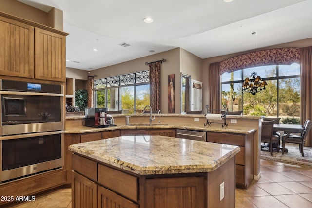 kitchen with appliances with stainless steel finishes, a center island, sink, and plenty of natural light