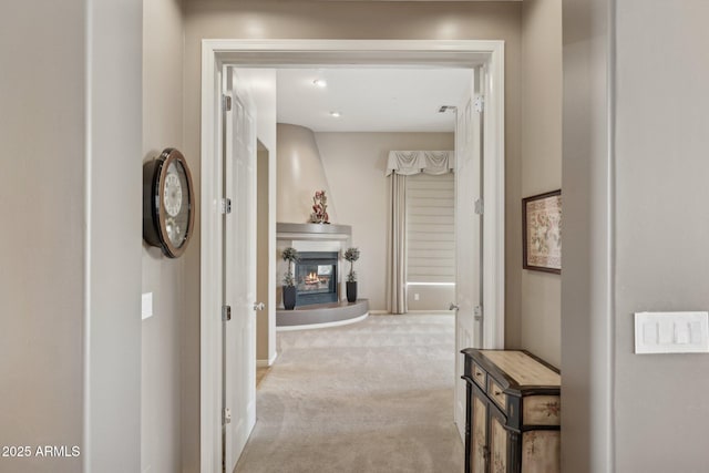 hall featuring light colored carpet