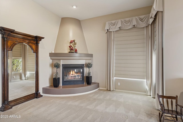 living room featuring a fireplace and light carpet