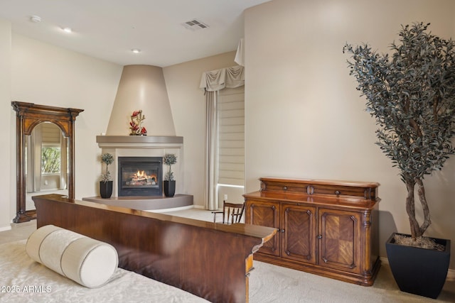 carpeted living room featuring a fireplace