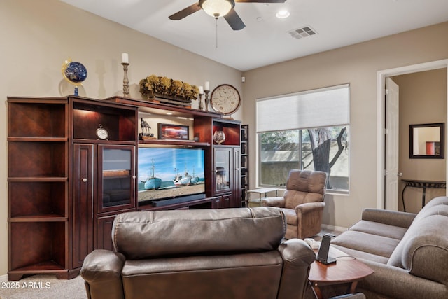 living room featuring ceiling fan and carpet