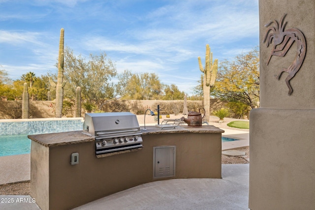 view of patio / terrace featuring exterior kitchen, area for grilling, and a fenced in pool