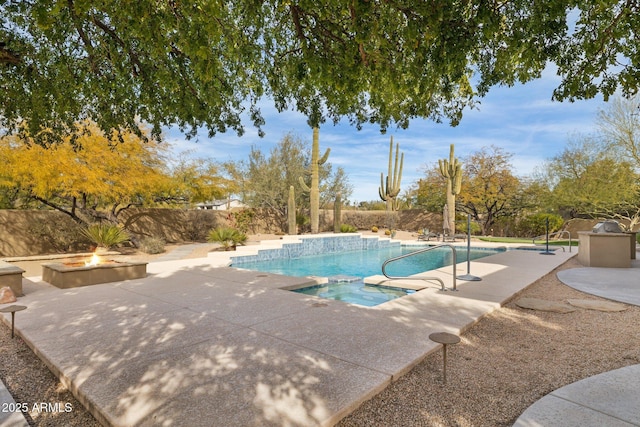 view of pool featuring an in ground hot tub, a patio, and a fire pit