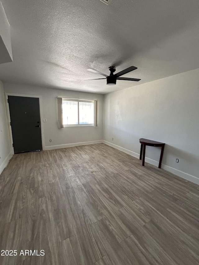 937 W Cocopah St, Phoenix, AZ 85007 - unfurnished living room with a ceiling fan, wood finished floors, a textured ceiling, and baseboards