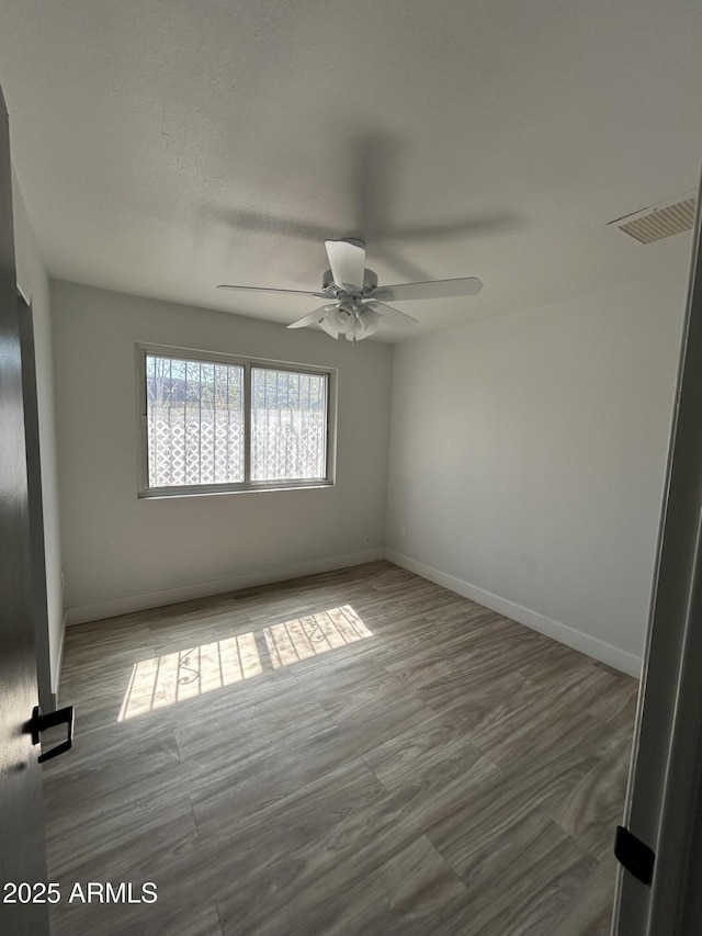 937 W Cocopah St, Phoenix, AZ 85007 - unfurnished bedroom featuring a ceiling fan, baseboards, and wood finished floors
