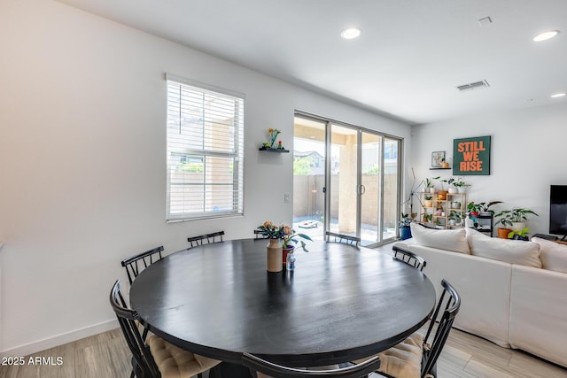 dining room featuring light wood finished floors, visible vents, and recessed lighting
