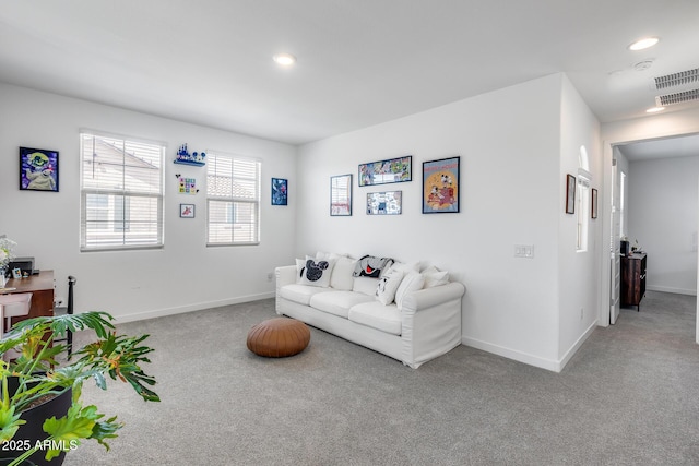 carpeted living room with visible vents, baseboards, and recessed lighting