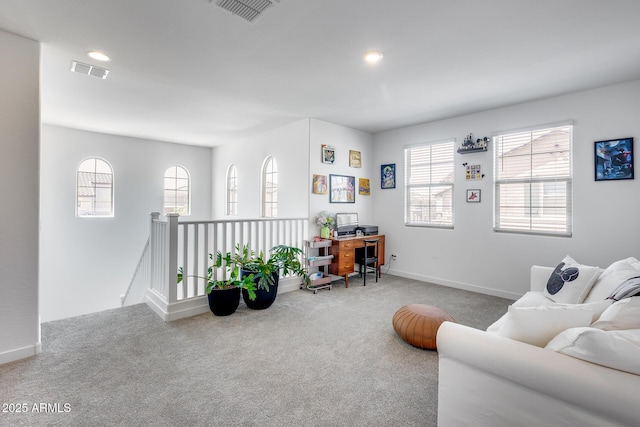 carpeted living area featuring visible vents, baseboards, and recessed lighting