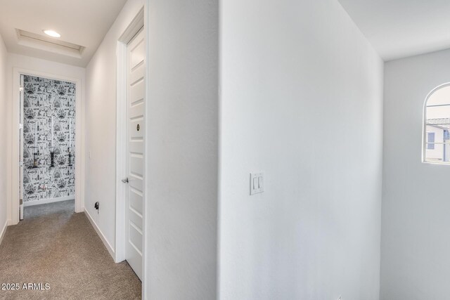 hallway featuring baseboards, recessed lighting, attic access, and light colored carpet