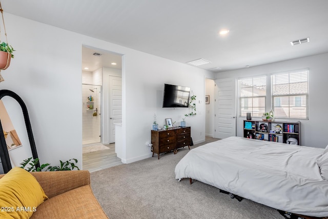 carpeted bedroom with ensuite bath, visible vents, and recessed lighting
