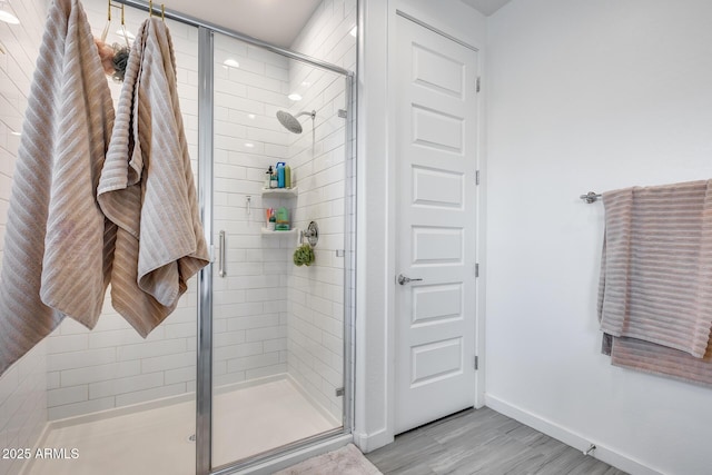 full bathroom with baseboards and a stall shower