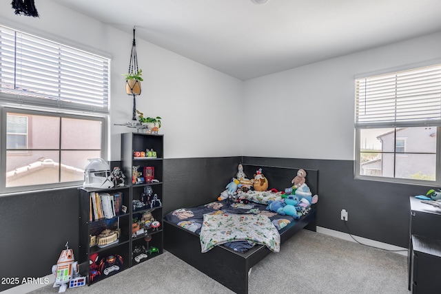 bedroom with carpet flooring and multiple windows