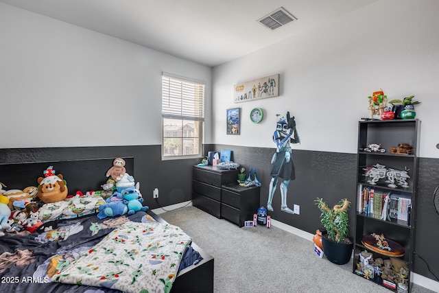 bedroom with visible vents, baseboards, and carpet