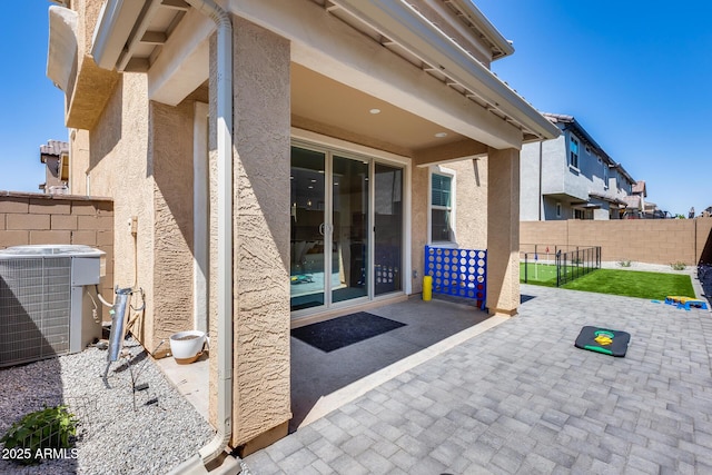 view of patio featuring central air condition unit and fence